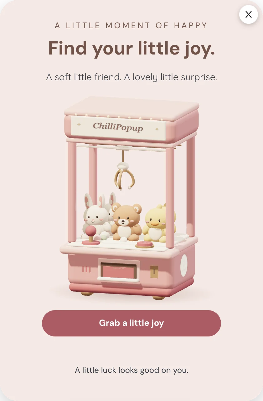 Little Joys, the starter Claw Machine theme: a cozy 3D cabinet with plush toys and a GRAB button on a blush card